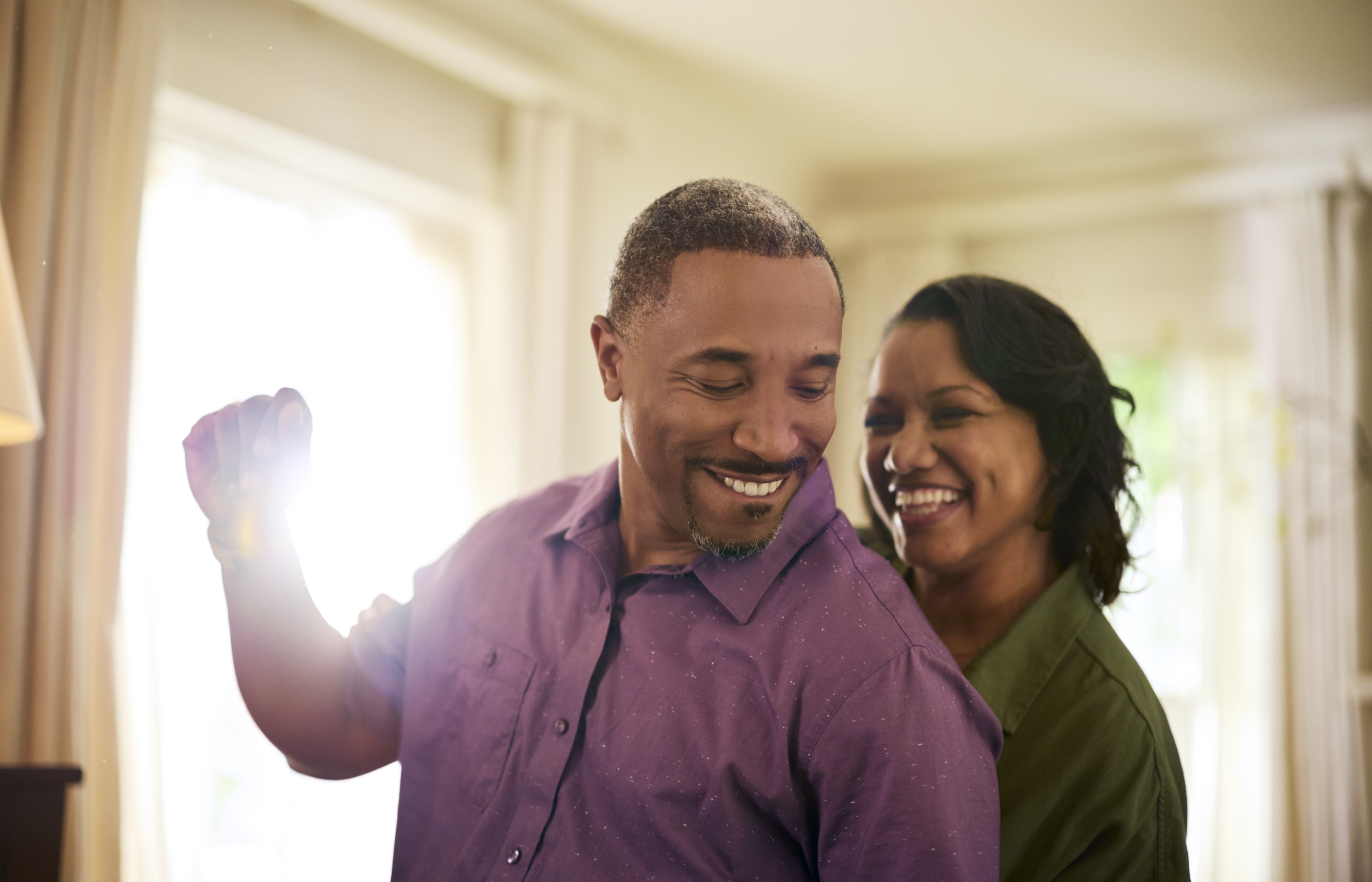 Couple of adults at home dancing