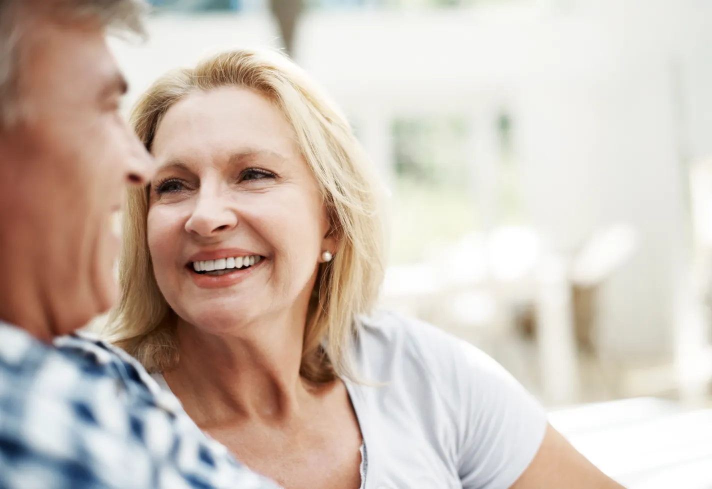 Loving senior couple at smiling at each other. 