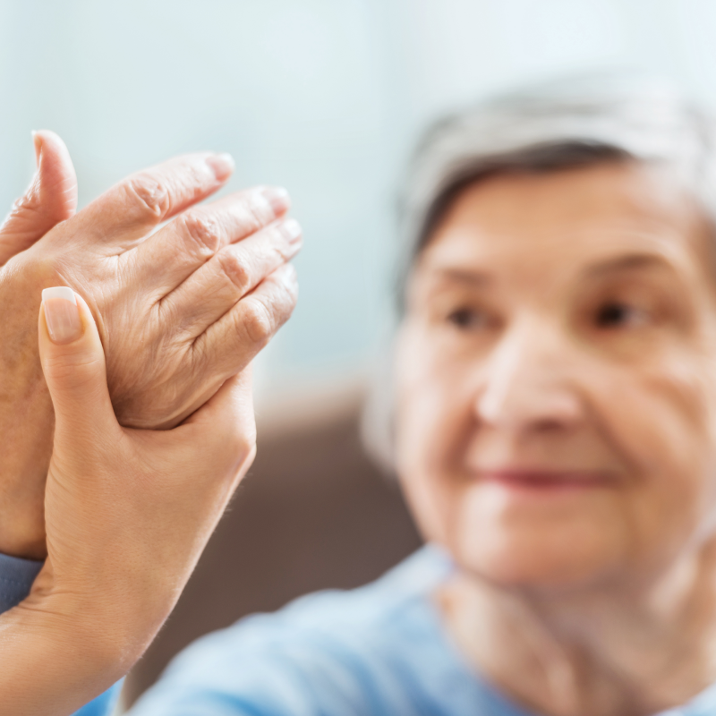senior woman with arthritis has hand examined