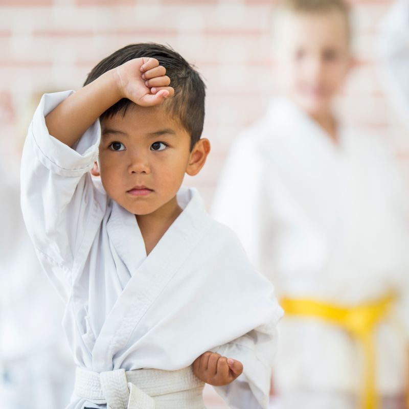 A young boy is participating in martial arts