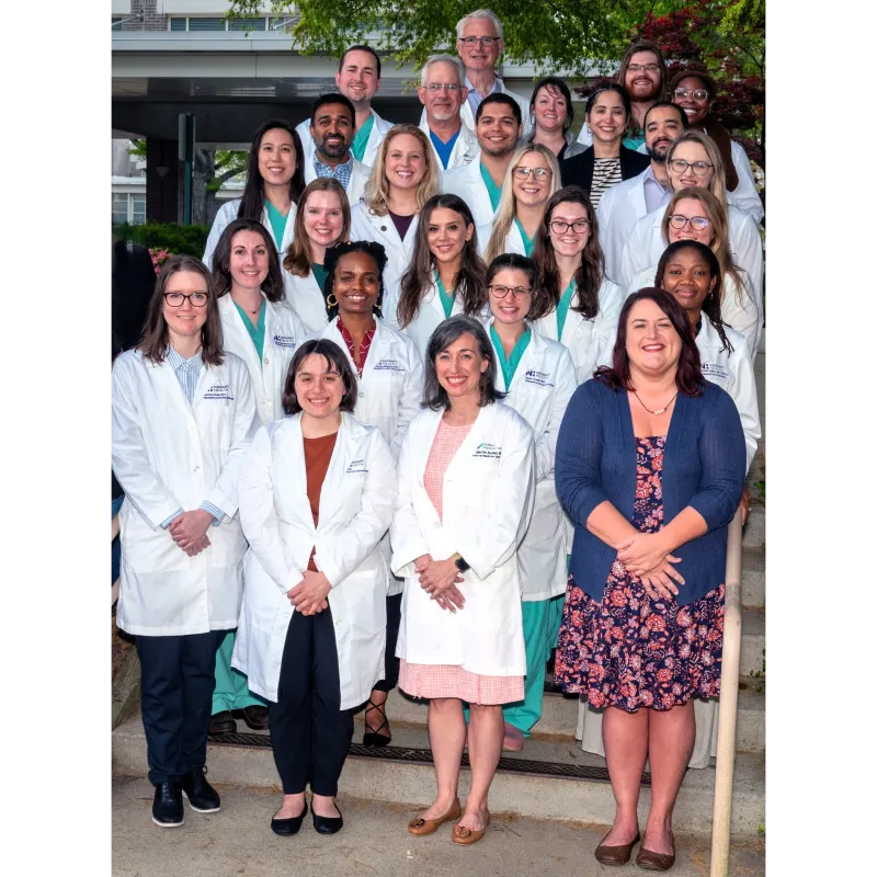 Group of Novant Health NHRMC OB-GYN residents in their white coats.