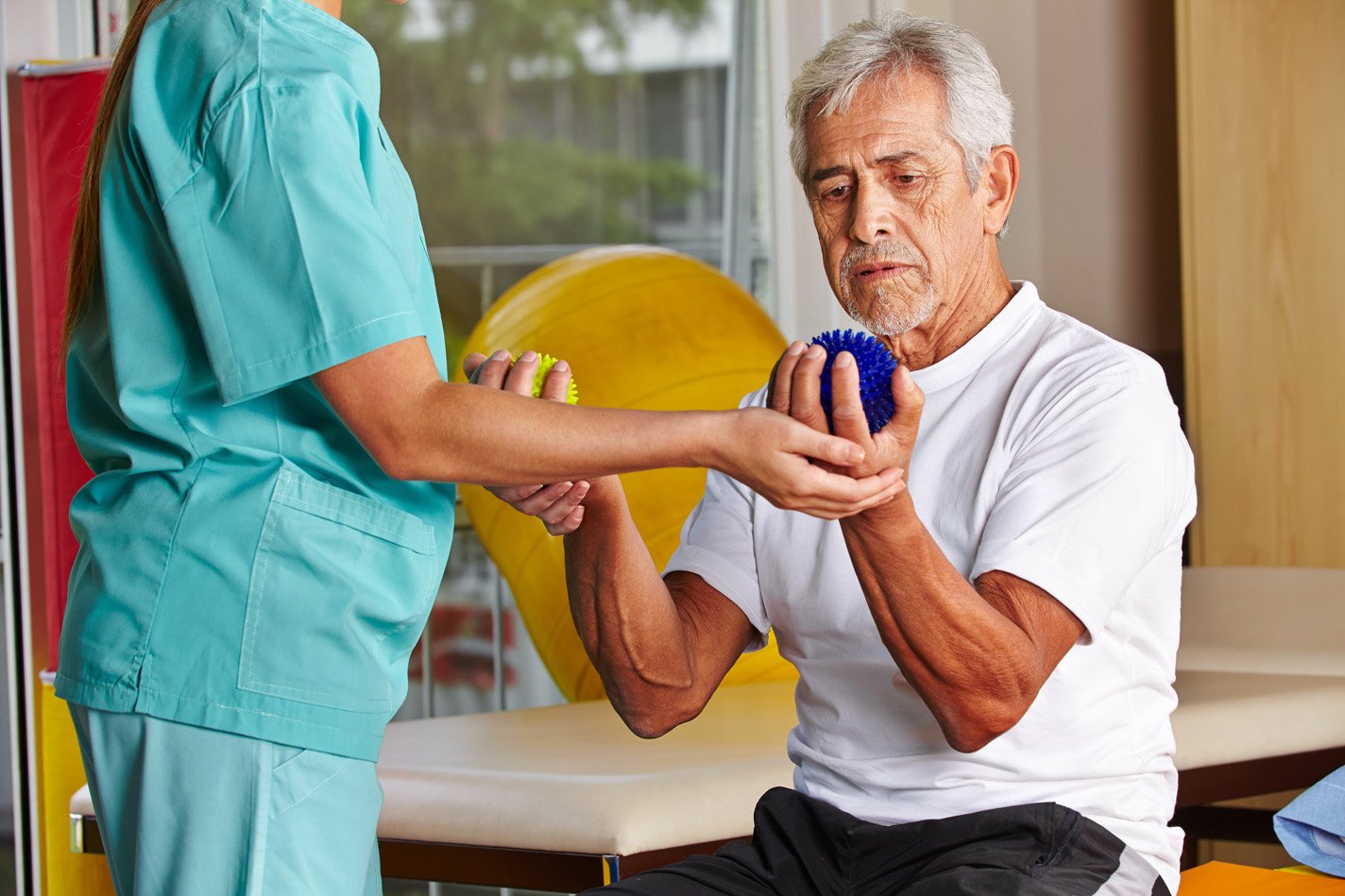 Using ball squeeze hand therapy