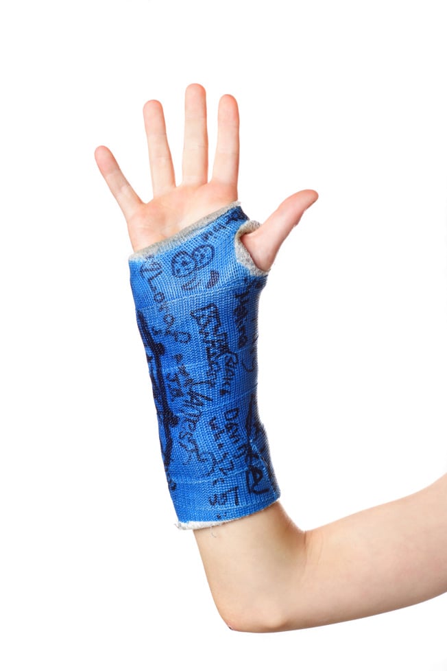 Child's hand with a signed cast.