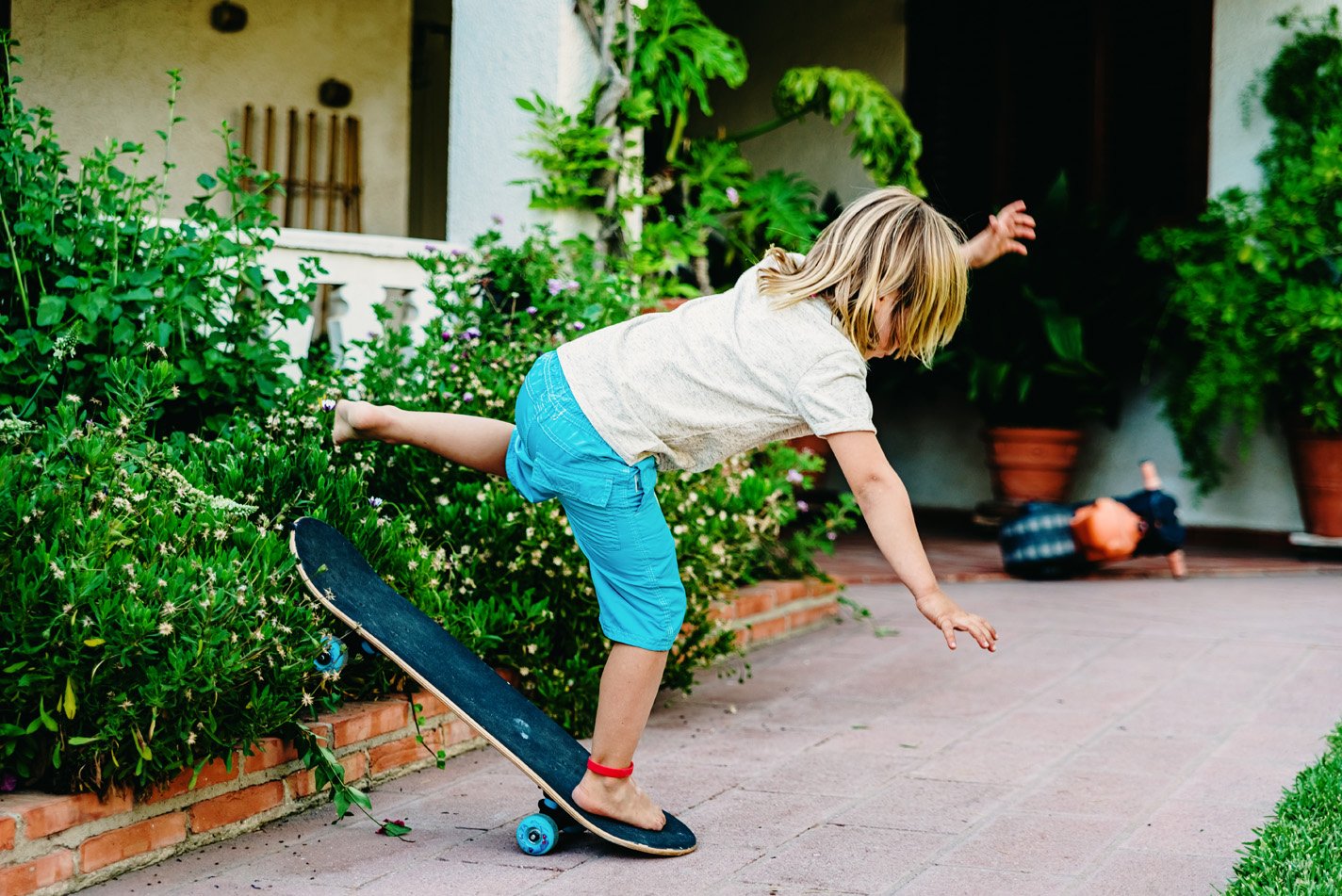 Child falling off a skateboard