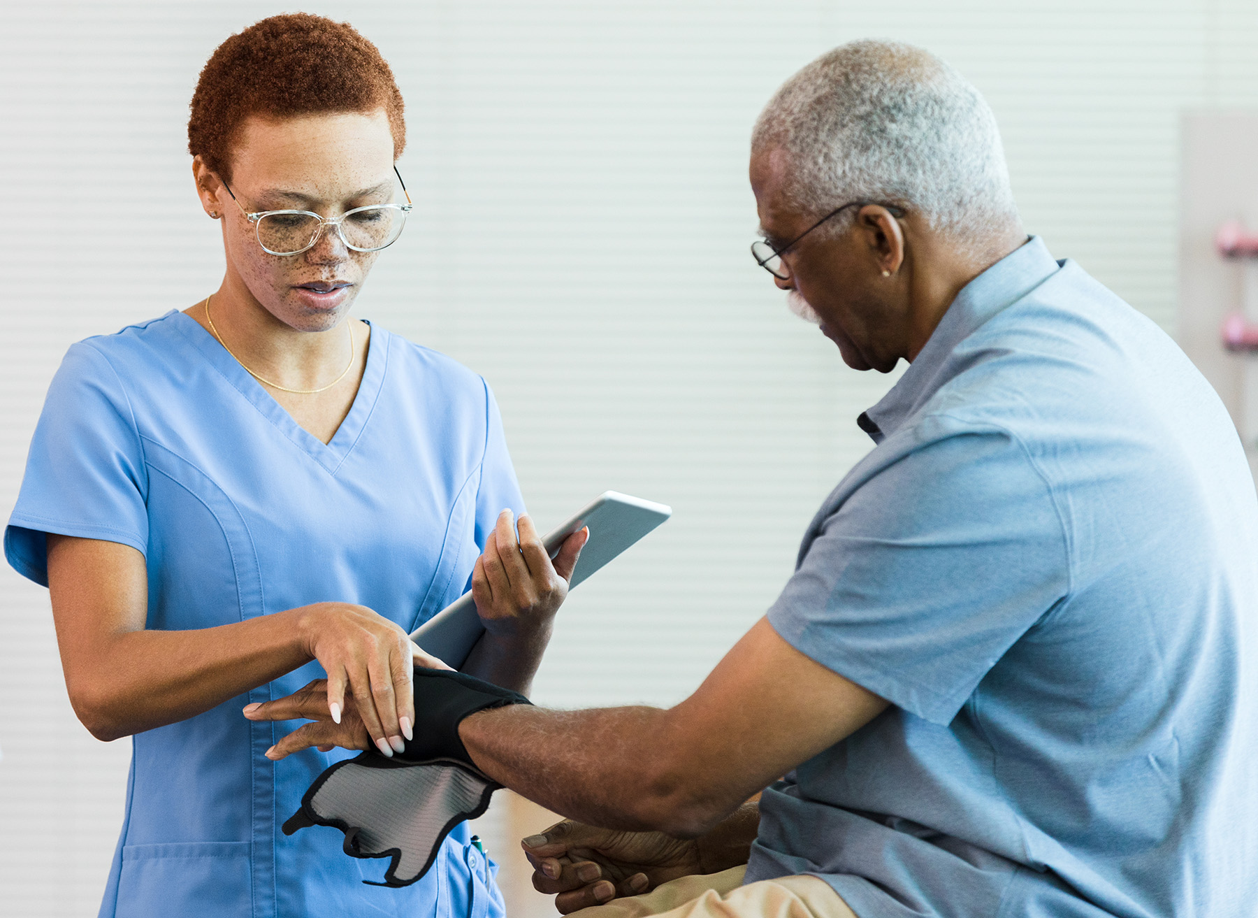 Nurse examines a patient's hand and wrist