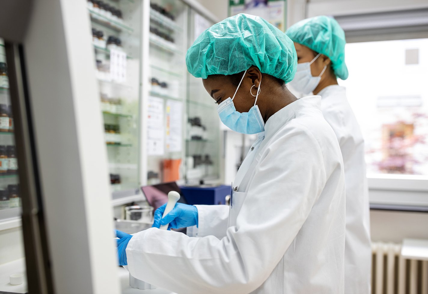 Two medical professionals testing samples in a laboratory Two medical professionals testing samples in a laboratory